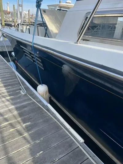 Warrior Yacht Photos Pics 2005 Albin 45 Command Bridge docked, side view with blue hull and white deck.