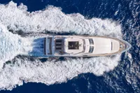 Aerial view of 2007 Custom Line 97 yacht cruising through blue ocean waters.