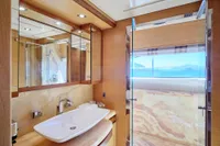 Luxurious bathroom on 2007 Custom Line 97 yacht with modern fixtures and ocean view.