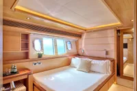 Luxurious cabin interior of 2007 Custom Line 97 yacht with elegant wood finish.