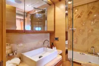 Luxurious yacht bathroom with modern sink and elegant wood accents, Custom Line 97, 2007.