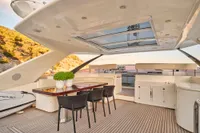 Luxurious 2007 Custom Line 97 yacht deck with elegant seating and dining area.