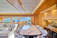 Luxurious interior of 2007 Custom Line 97 yacht with elegant dining area and scenic ocean view.