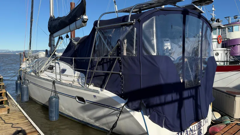  Yacht Photos Pics Catalina 470 sailboat, 2004 model, docked with blue canvas cover and clear windows.