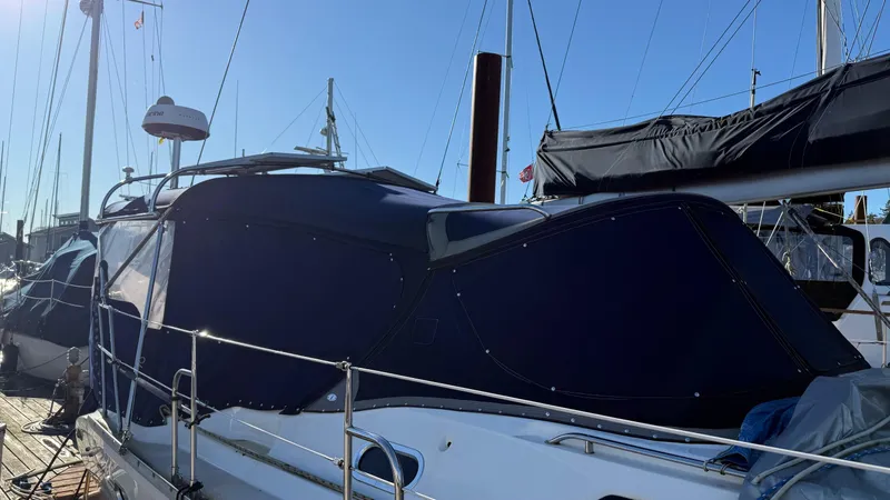  Yacht Photos Pics 2004 Catalina 470 sailboat docked with blue canvas cover under clear sky.