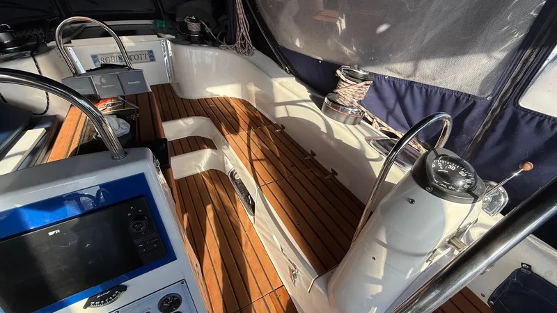  Yacht Photos Pics Cockpit of 2004 Catalina 470 sailboat with wooden flooring and navigation equipment.