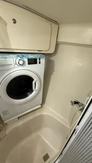  Yacht Photos Pics Laundry area in 2004 Catalina 470 yacht with washing machine and storage.