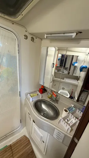  Yacht Photos Pics Bathroom interior of a 2004 Catalina 470 yacht with sink and mirror.