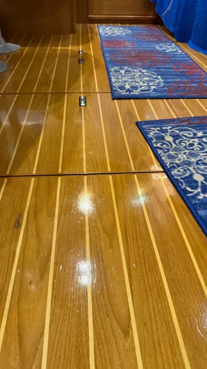  Yacht Photos Pics Polished wooden floor with blue patterned rugs on a 2004 Catalina 470 yacht.