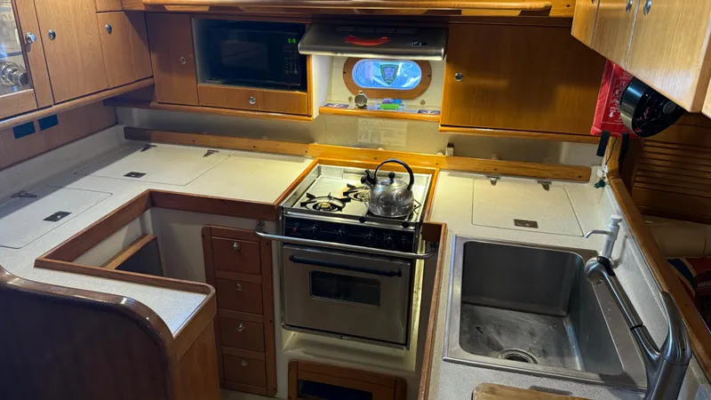  Yacht Photos Pics Galley kitchen in 2004 Catalina 470 yacht with stove, sink, and microwave.