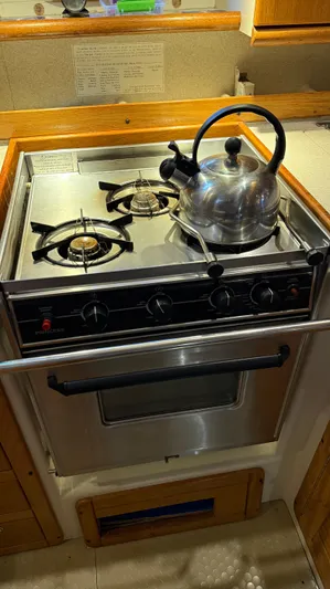  Yacht Photos Pics Stainless steel stove with kettle in 2004 Catalina 470 yacht kitchen.
