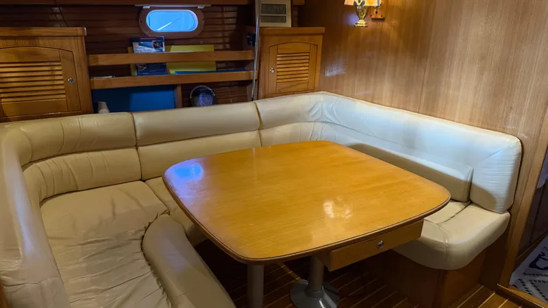  Yacht Photos Pics 2004 Catalina 470 yacht interior with cozy dining area and wooden table.