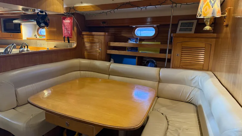  Yacht Photos Pics Interior of 2004 Catalina 470 yacht with cozy dining area and wooden finishes.