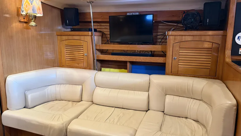 Yacht Photos Pics Luxurious interior of 2004 Catalina 470 yacht with cream leather seating and wooden cabinetry.