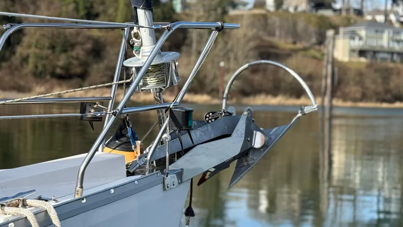  Yacht Photos Pics Bow of 2004 Catalina 470 sailboat with anchor and calm water background.