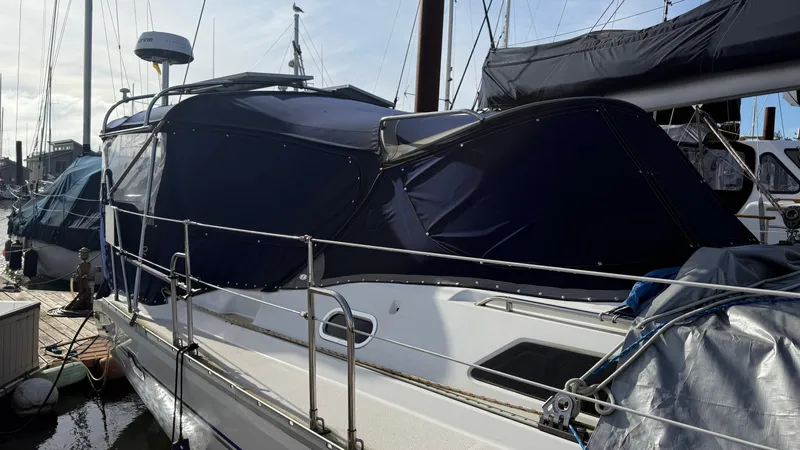  Yacht Photos Pics 2004 Catalina 470 sailboat docked with blue canvas cover.