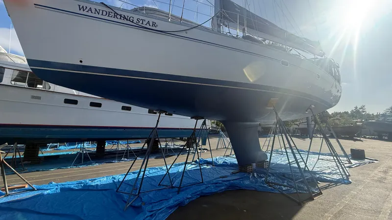  Yacht Photos Pics Catalina 470 sailboat "Wandering Star" on stands, sunlit, 2004 model, in a boatyard.