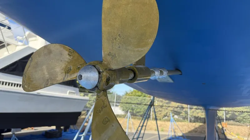  Yacht Photos Pics Close-up of a Catalina 470 sailboat propeller, 2004 model, on a blue hull.