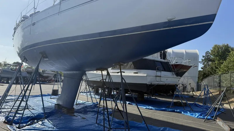  Yacht Photos Pics Catalina 470 sailboat from 2004 on stands, undergoing maintenance in a boatyard.