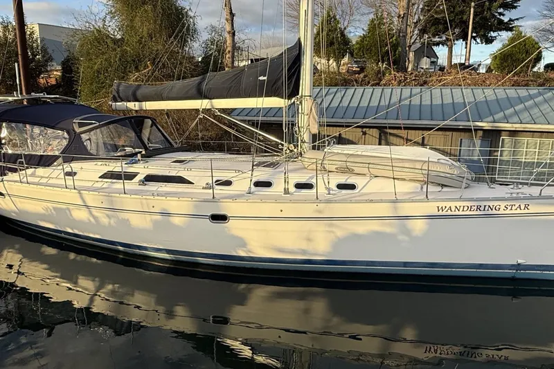 Yacht Photos Pics Sailboat "Wandering Star," Catalina 470, 2004 model, docked with reflections on water.