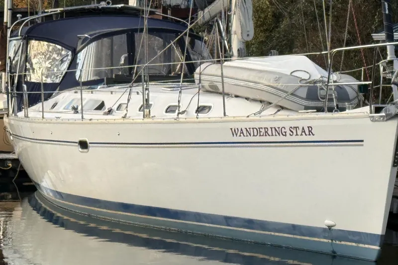  Yacht Photos Pics 2004 Catalina 470 sailboat named "Wandering Star" docked in a marina.