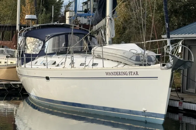  Yacht Photos Pics Catalina 470 sailboat "Wandering Star" docked, 2004 model, with blue canopy.