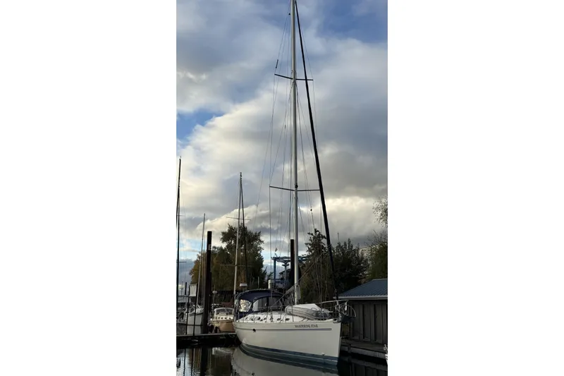  Yacht Photos Pics 2004 Catalina 470 sailboat docked under cloudy sky.