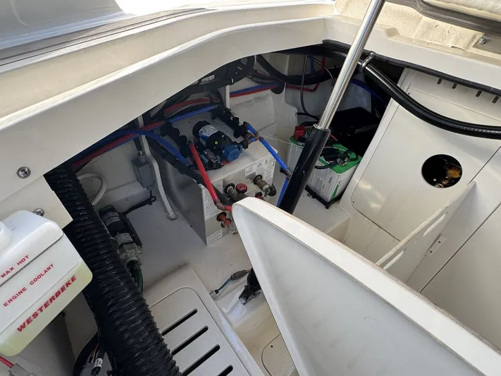  Yacht Photos Pics Engine compartment of 2024 Sea Ray Sundancer 320 Outboard, showing battery and wiring components.