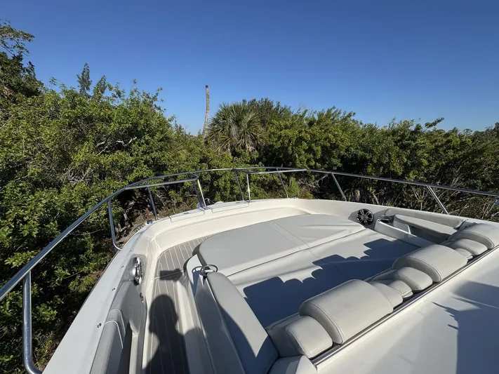  Yacht Photos Pics 2024 Sea Ray Sundancer 320 Outboard bow with lush greenery and clear blue sky.