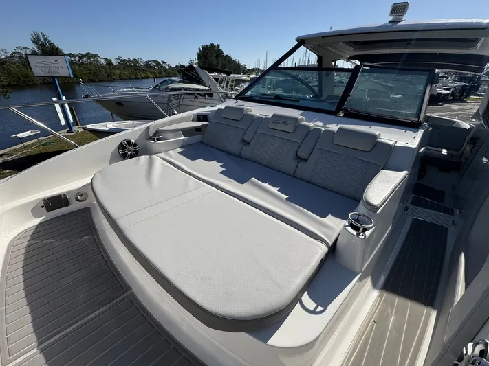  Yacht Photos Pics 2024 Sea Ray Sundancer 320 Outboard with spacious seating and sleek design at a marina.