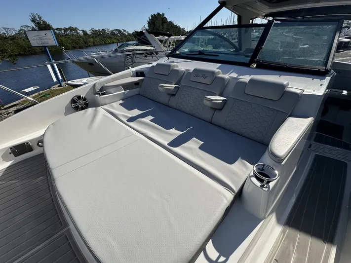  Yacht Photos Pics 2024 Sea Ray Sundancer 320 Outboard with luxurious seating and sleek design at a marina.