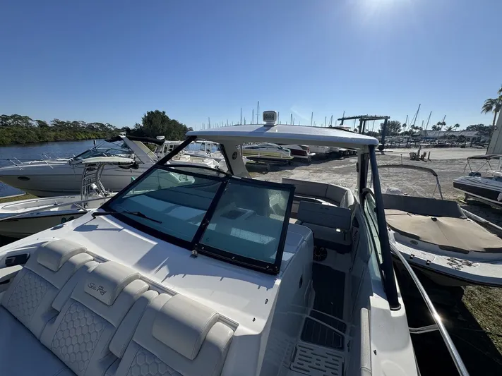  Yacht Photos Pics 2024 Sea Ray Sundancer 320 Outboard docked, showcasing sleek design and spacious seating.