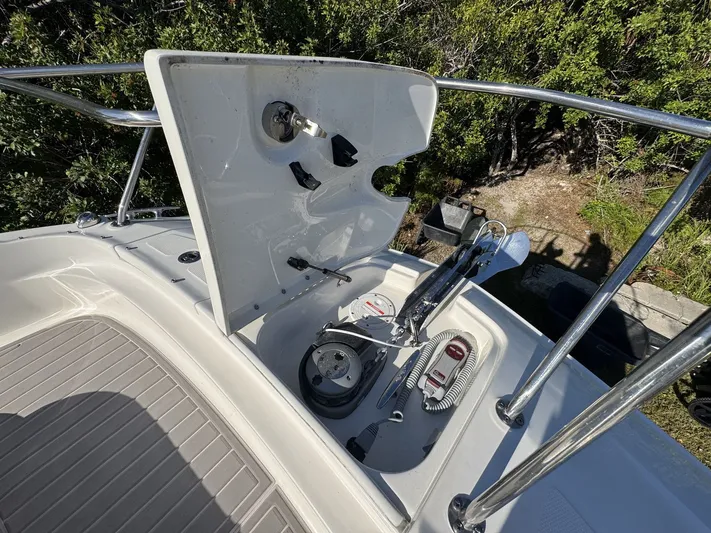  Yacht Photos Pics 2024 Sea Ray Sundancer 320 Outboard anchor compartment with open hatch, showcasing anchor and equipment.