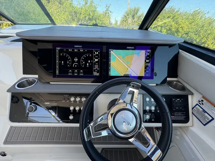  Yacht Photos Pics 2024 Sea Ray Sundancer 320 Outboard dashboard with Simrad displays and modern steering wheel.