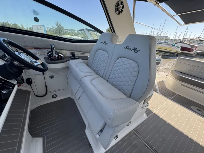 Yacht Photos Pics 2024 Sea Ray Sundancer 320 Outboard cockpit with luxurious seating and modern controls.