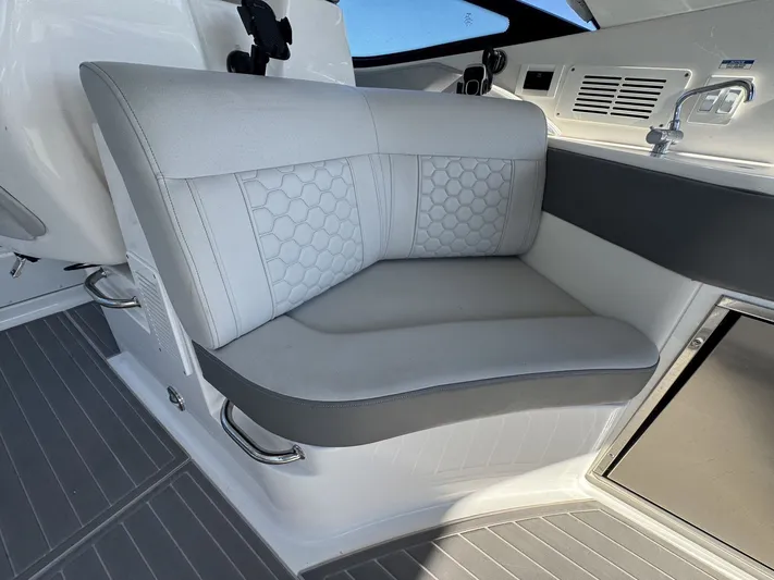  Yacht Photos Pics 2024 Sea Ray Sundancer 320 Outboard interior seating with modern design and gray upholstery.