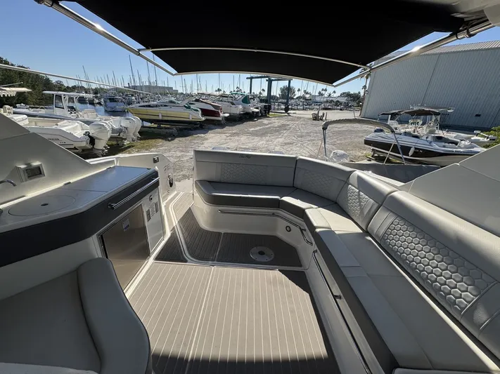  Yacht Photos Pics 2024 Sea Ray Sundancer 320 Outboard interior with seating and kitchenette, docked at marina.
