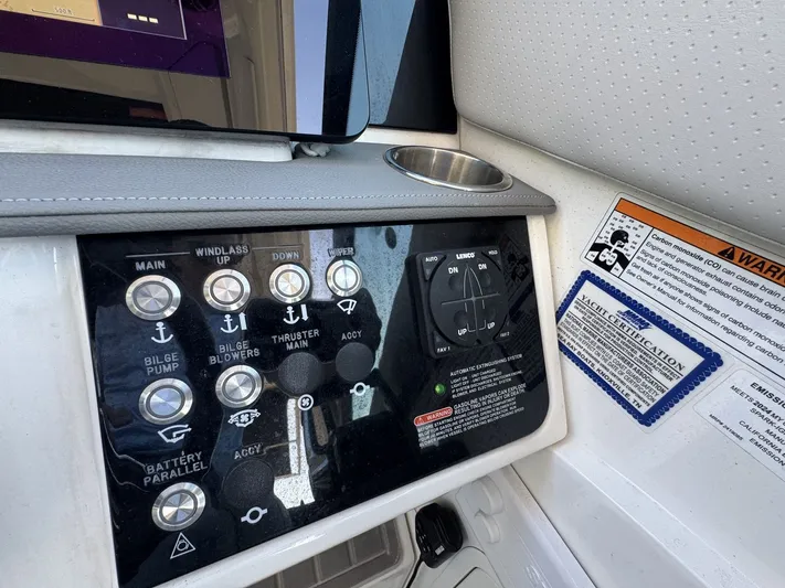  Yacht Photos Pics Control panel of 2024 Sea Ray Sundancer 320 Outboard with various switches and warning labels.