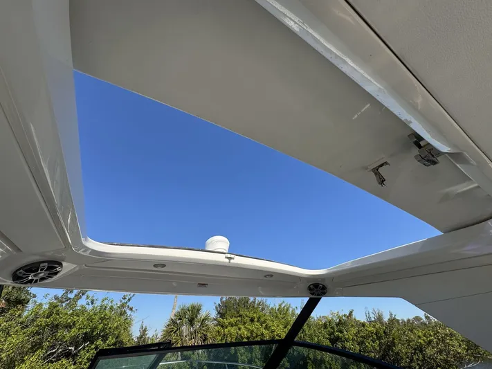  Yacht Photos Pics 2024 Sea Ray Sundancer 320 Outboard boat with open sunroof and clear blue sky.