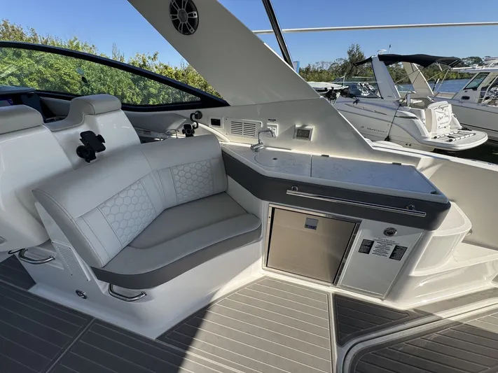 Yacht Photos Pics 2024 Sea Ray Sundancer 320 Outboard interior with seating and kitchenette.