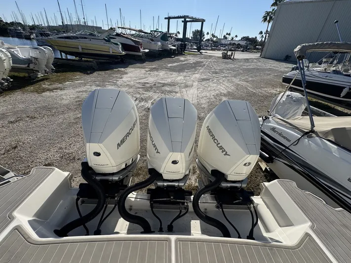  Yacht Photos Pics Triple Mercury outboard engines on a 2024 Sea Ray Sundancer 320, docked at a marina.