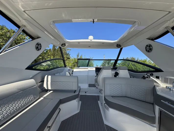  Yacht Photos Pics 2024 Sea Ray Sundancer 320 Outboard interior with sleek seating and panoramic windows.