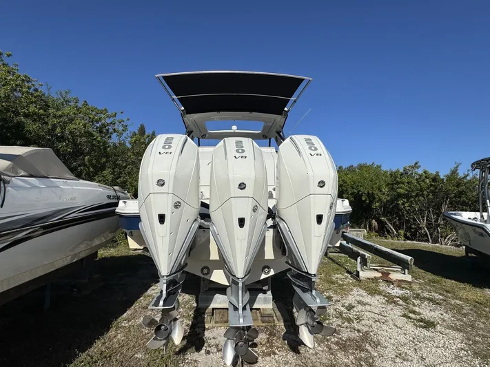  Yacht Photos Pics 2024 Sea Ray Sundancer 320 Outboard with triple Mercury V8 engines, docked outdoors.