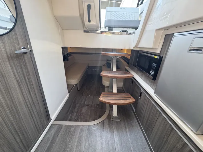  Yacht Photos Pics 2024 Sea Ray Sundancer 320 Outboard interior with wooden steps, microwave, and modern design.