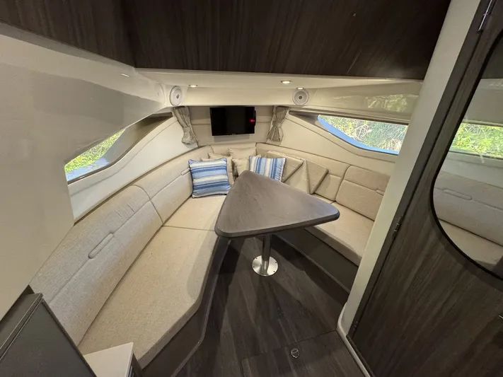 Yacht Photos Pics 2024 Sea Ray Sundancer 320 Outboard cabin interior with cozy seating and modern design.