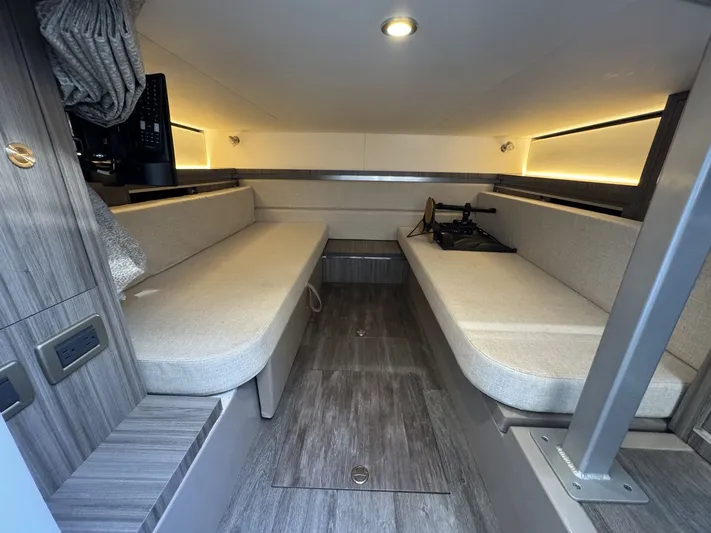  Yacht Photos Pics 2024 Sea Ray Sundancer 320 Outboard cabin interior with modern seating and wood accents.