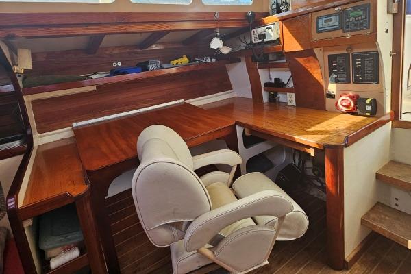 Interior of 2002 Parker Marine Lorcha 50, featuring a wooden desk and comfortable chair.