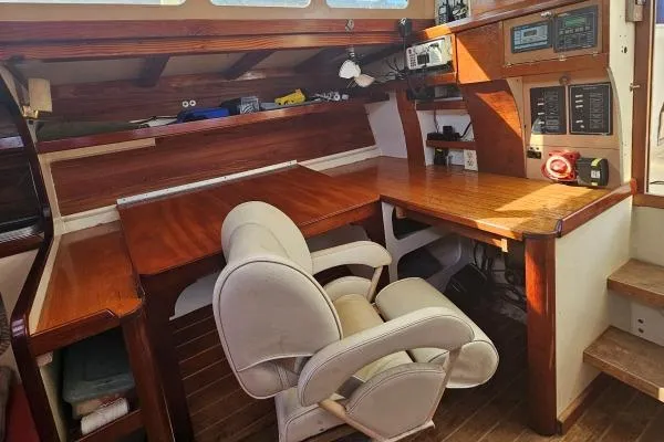 Interior of 2002 Parker Marine Lorcha 50, featuring a wooden desk and comfortable chair.
