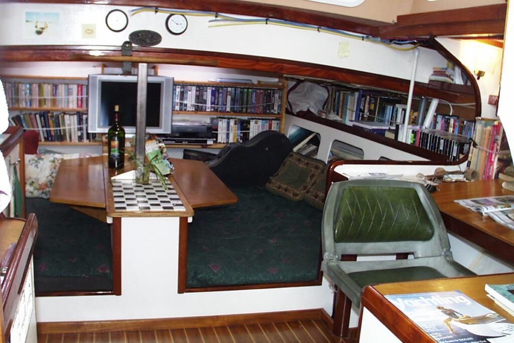 Interior of 2002 Parker Marine Lorcha 50 yacht with bookshelves and seating area.