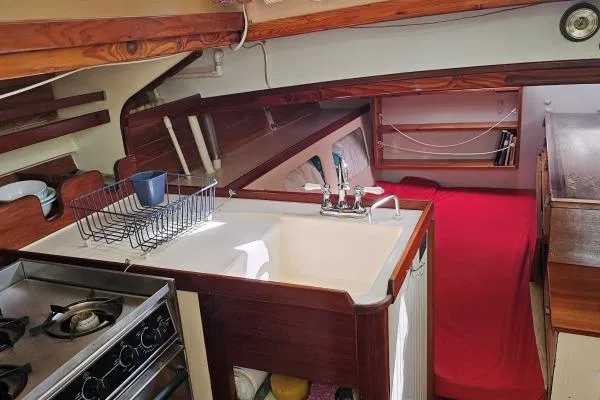 Tien Hou Yacht Photos Pics Interior of 2002 Parker Marine Lorcha 50 sailboat with kitchen and cozy sleeping area.